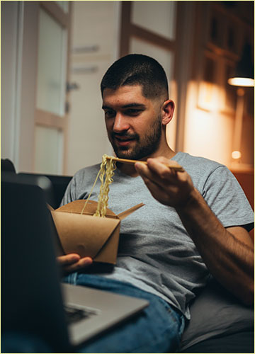 Guy Eating Chinese Food Late at Night